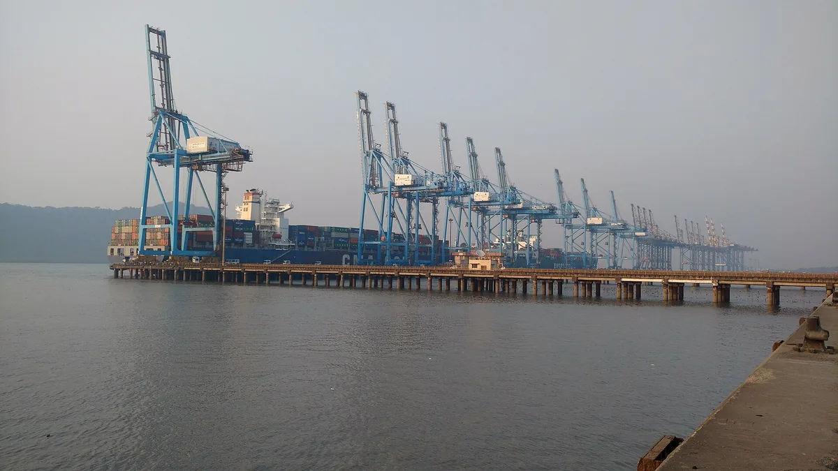 Container cranes loading a ship at Jawaharlal Nehru Port, Navi Mumbai