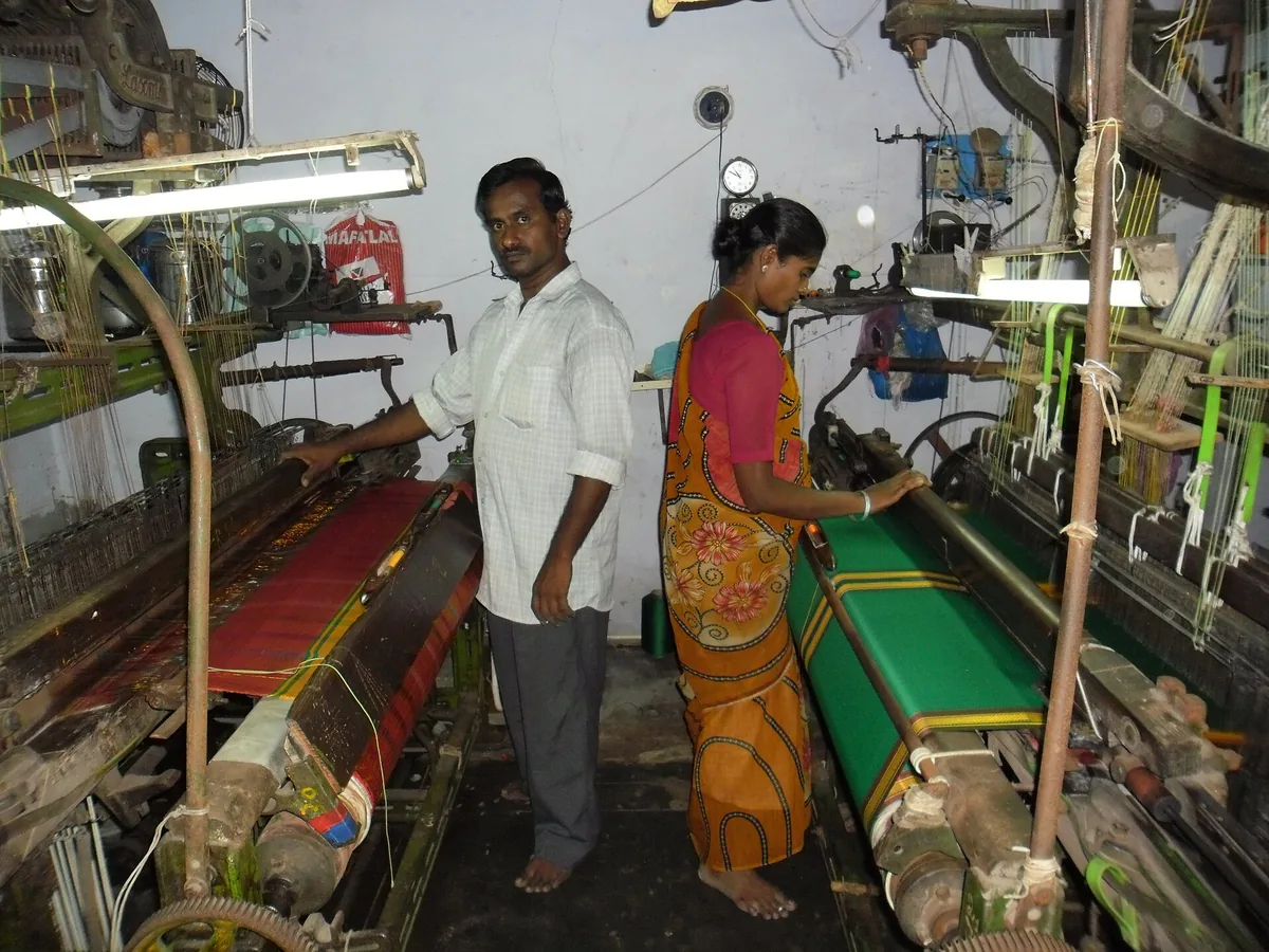 Workers operating power looms in a weaving unit in Salem, Tamil Nadu